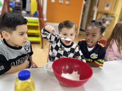 Preschool children enjoying hands-on cooking and science experiments as part of Sierra Preschool's summer curriculum